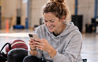 Coach smiling at her phone (AI-generated image)
